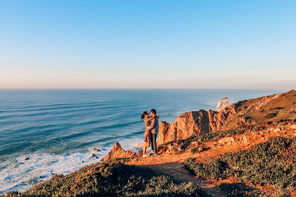 Couple hugging at Cabo da Roca at sunset, Sintra