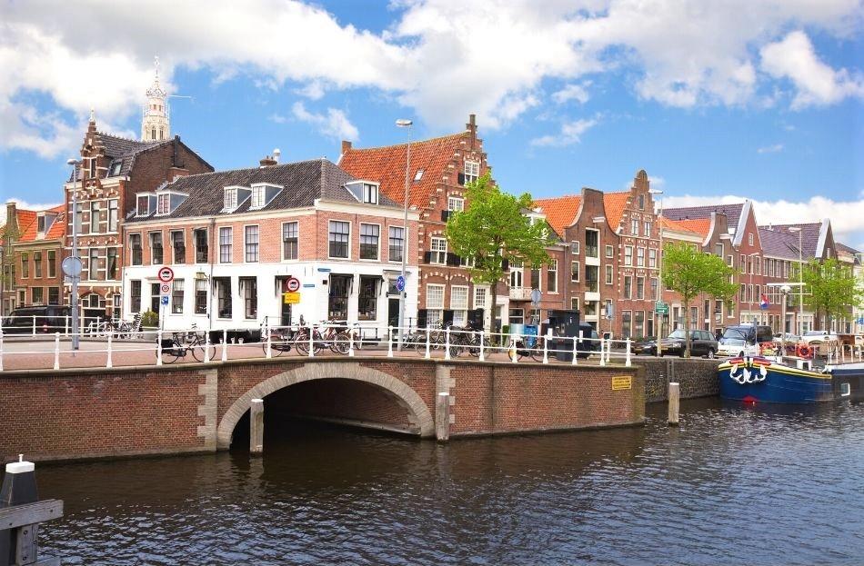 Dutch houses near a canal with a bridge in Haarlem, Netherlands