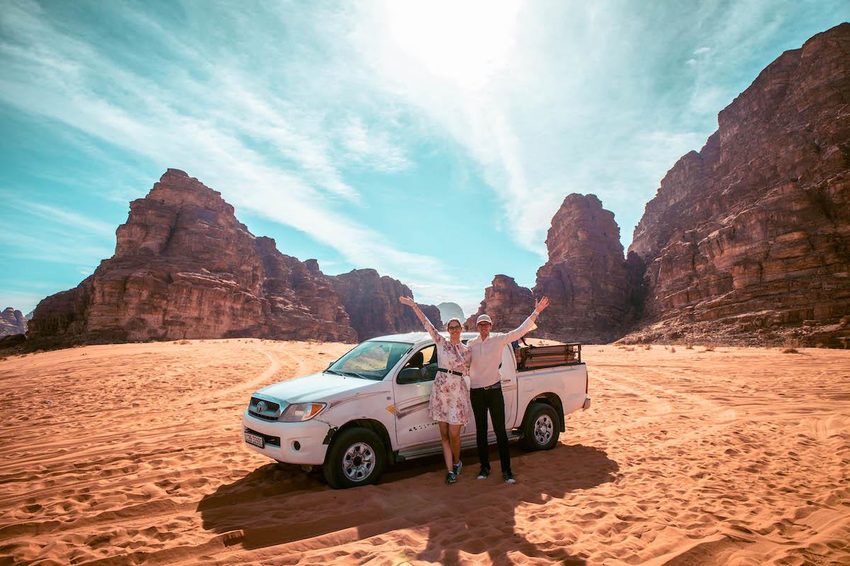 Couple and a jeep in Wadi Rum, Jordan